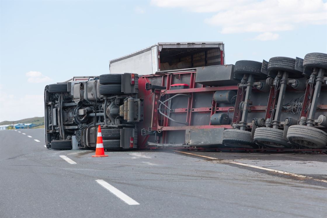 A truck that has been crashed on the side of the road

Description automatically generated